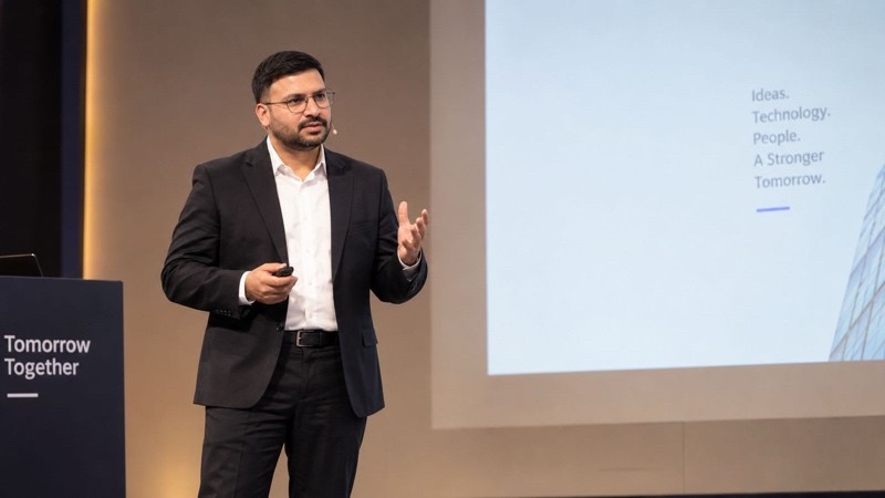 Speaker on stage delivering a technology session